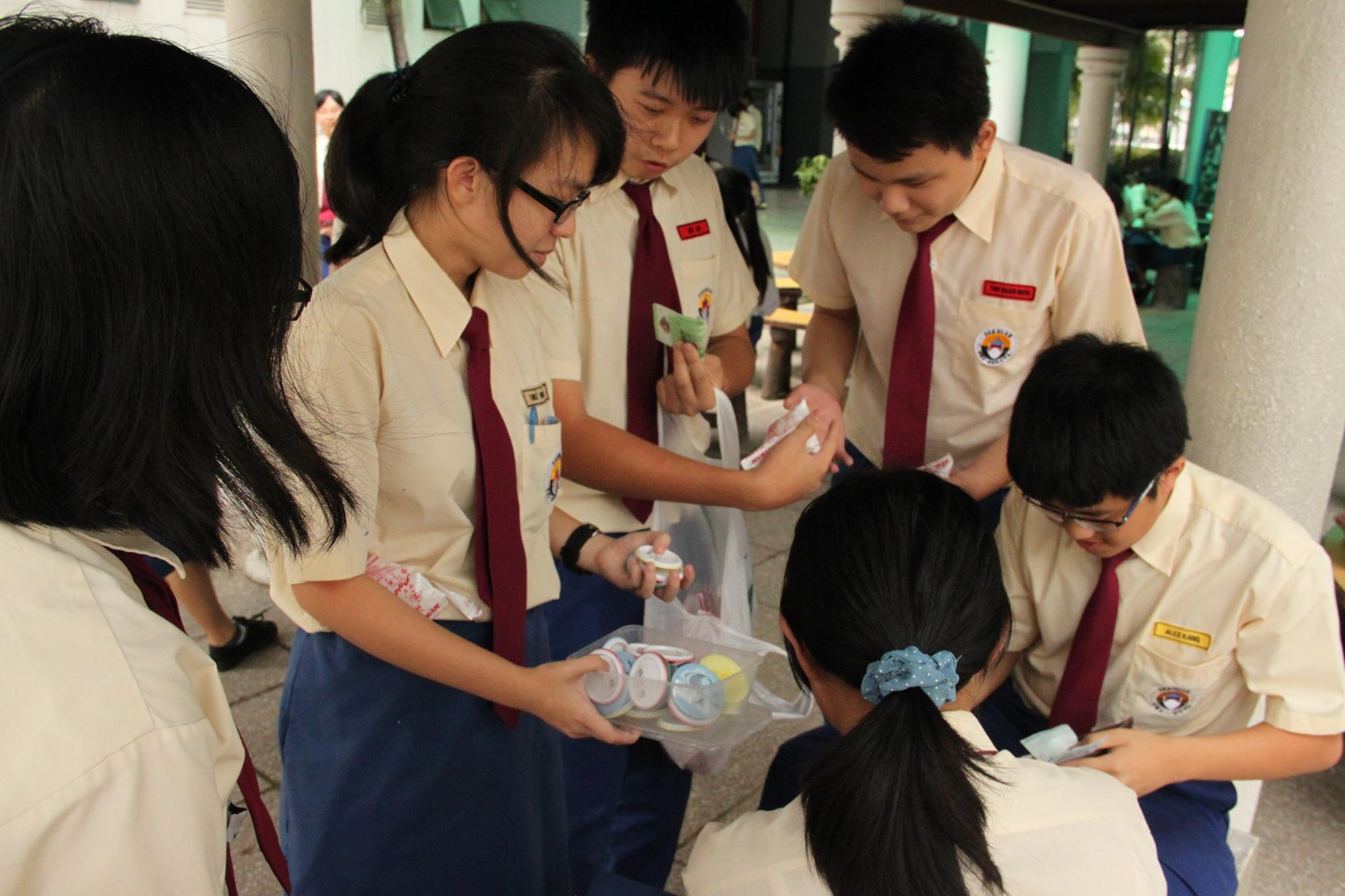 CARING STUDENTS: Students selling candies and badges to raise funds.